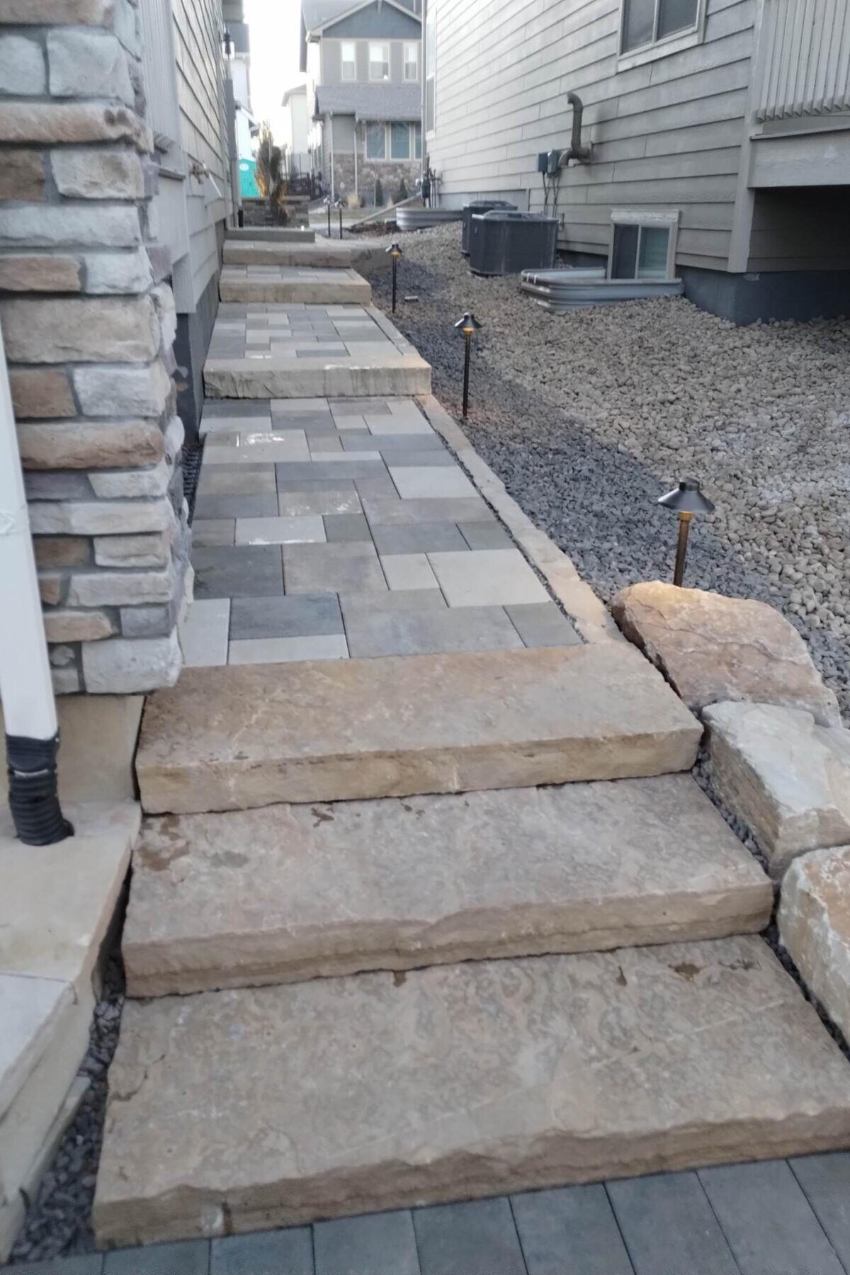Paver walkway with stone steps and accent lighting, Fort Collins.
